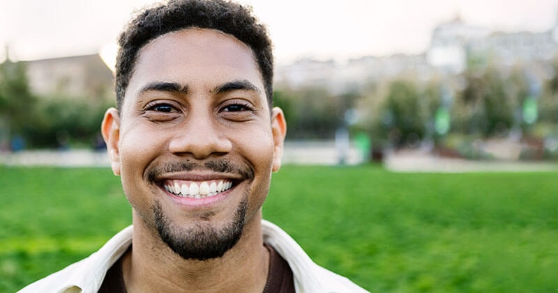 A man smiling that displays a positive emotional pattern.
