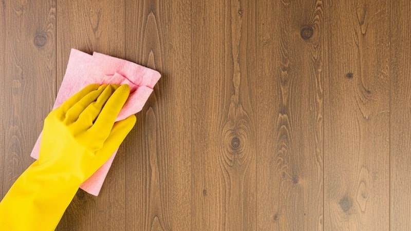 Women cleaning the PVC wood panel wall