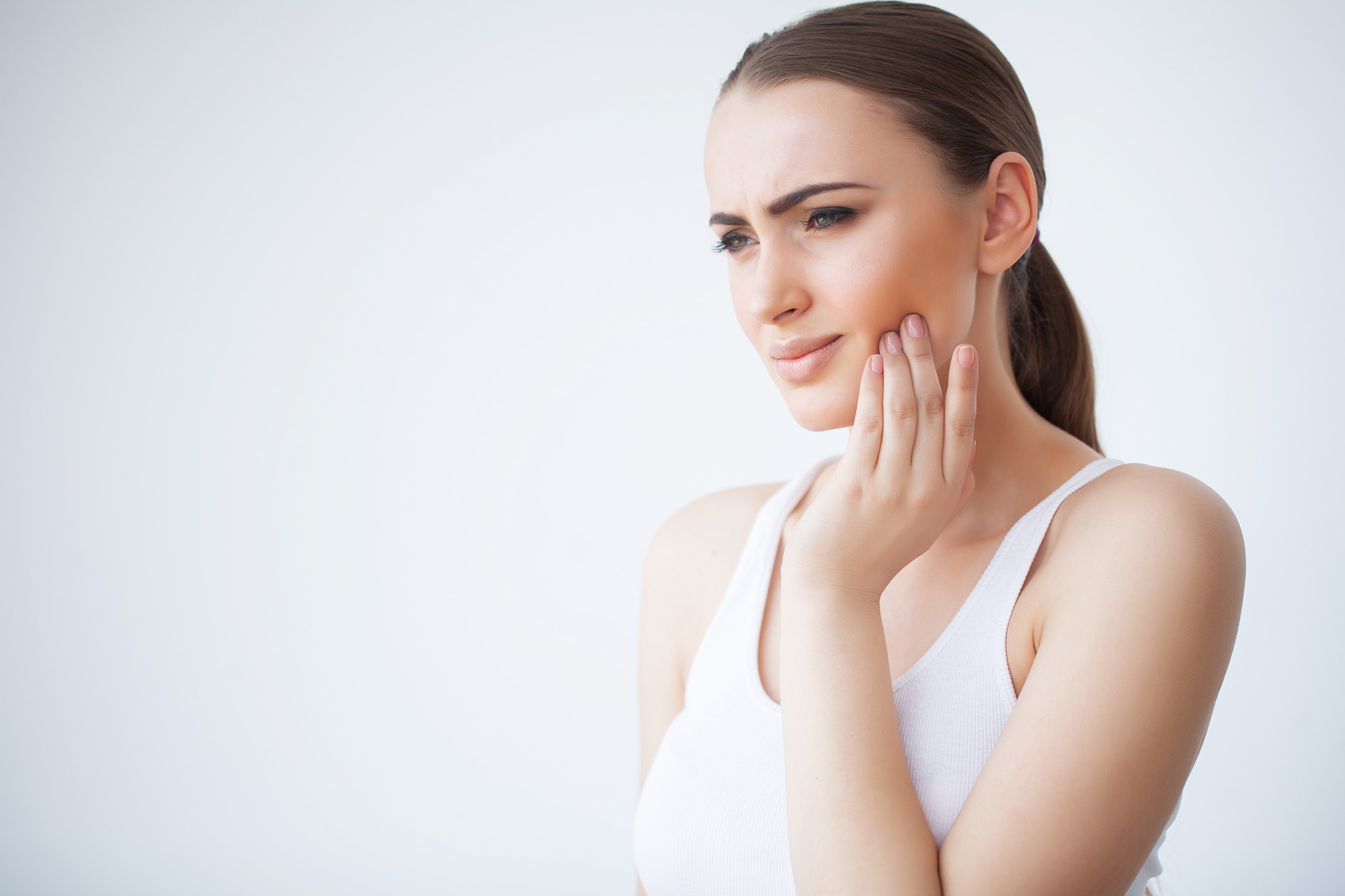 A photo of a woman who's on a healing process after wisdom tooth removal.