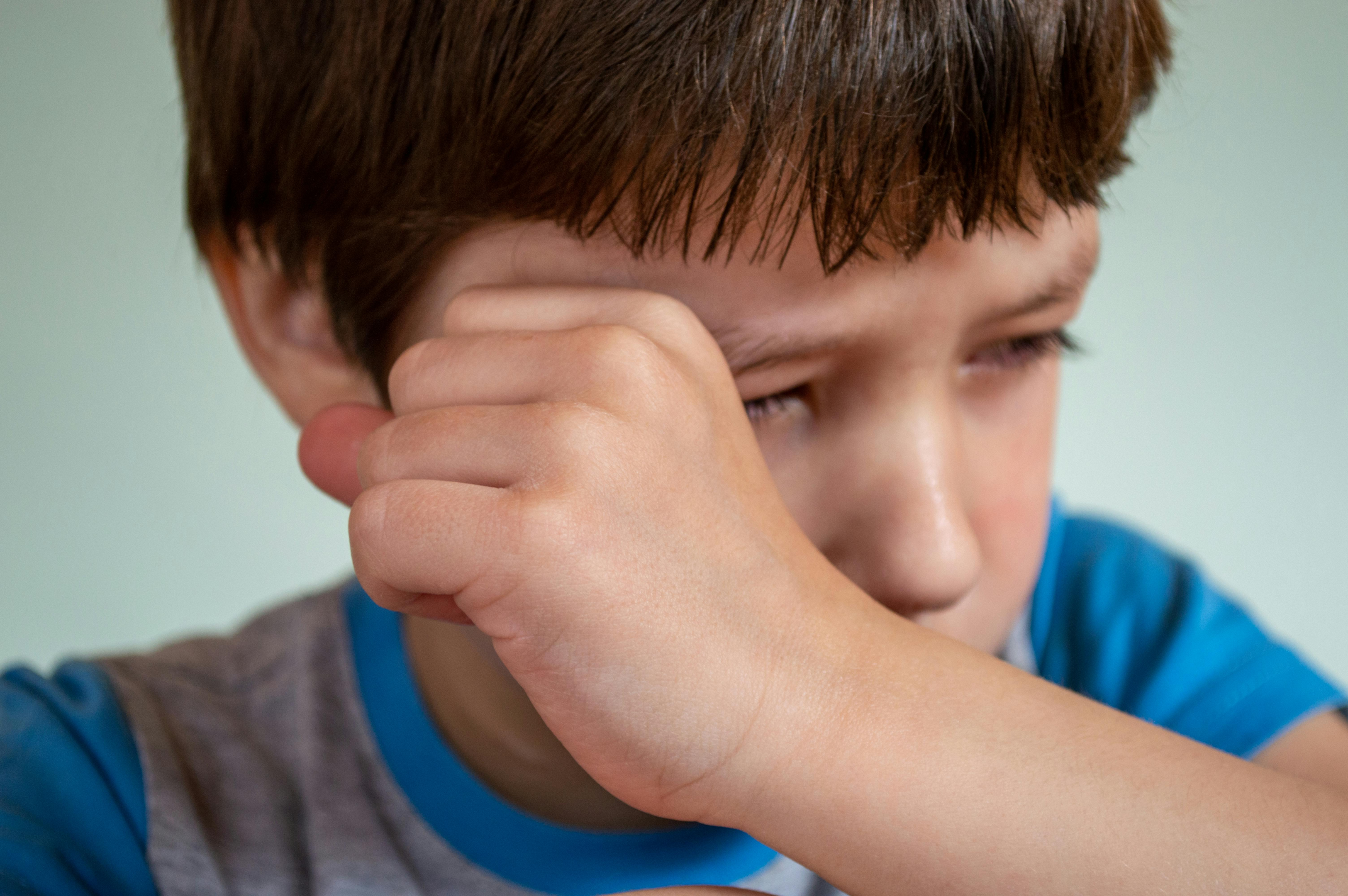 Young boy wiping his tears