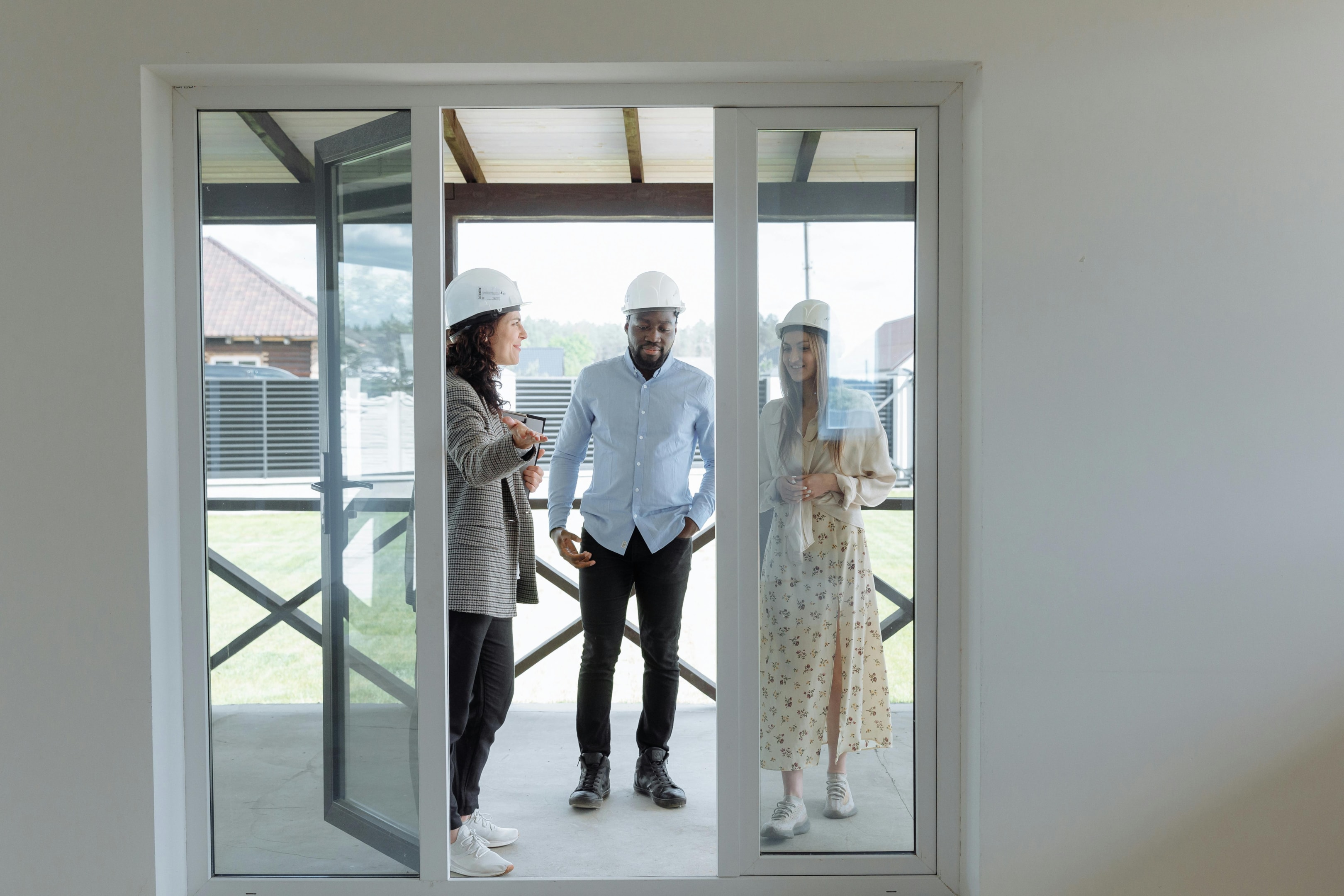 Contractor walks through house with real estate investors to show them progress on their active projects. 
