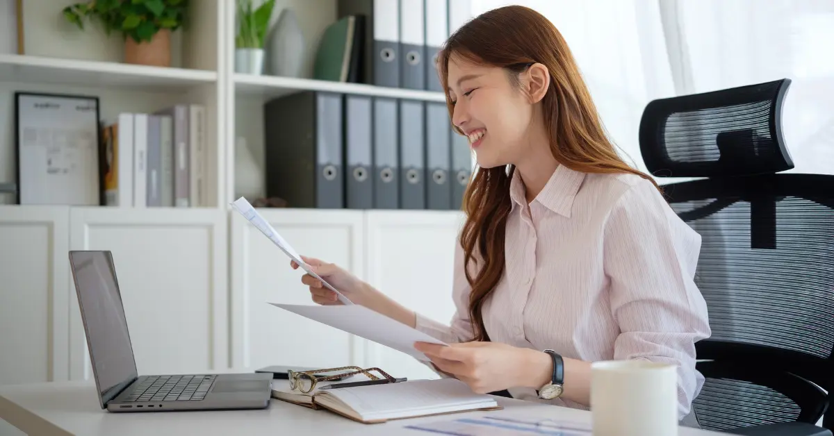 Woman reviewing tax checklist while deciding owners draw vs salary LLC for her OnlyFans business.