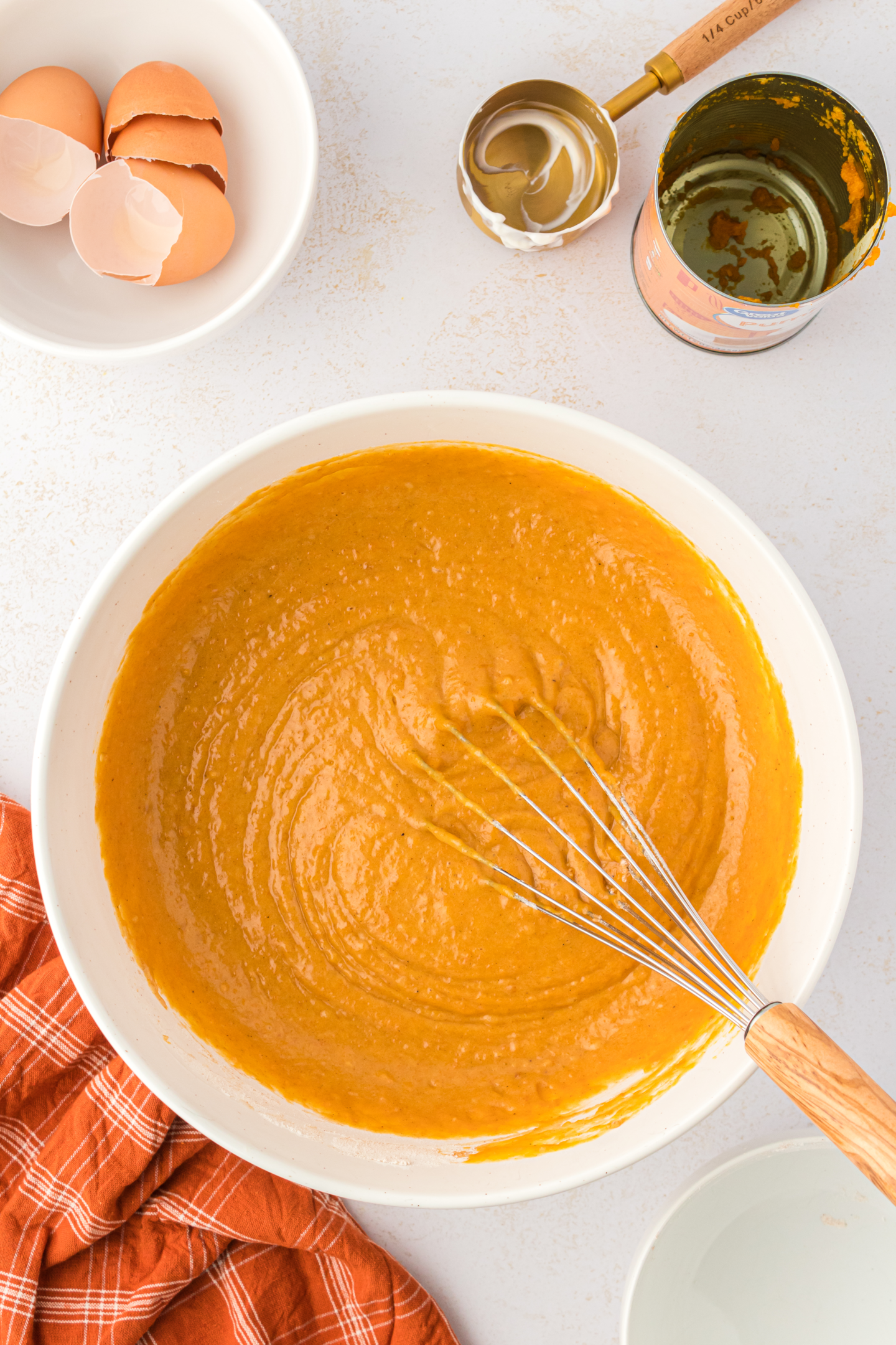pumpkin bars batter in a bowl with a whisk
