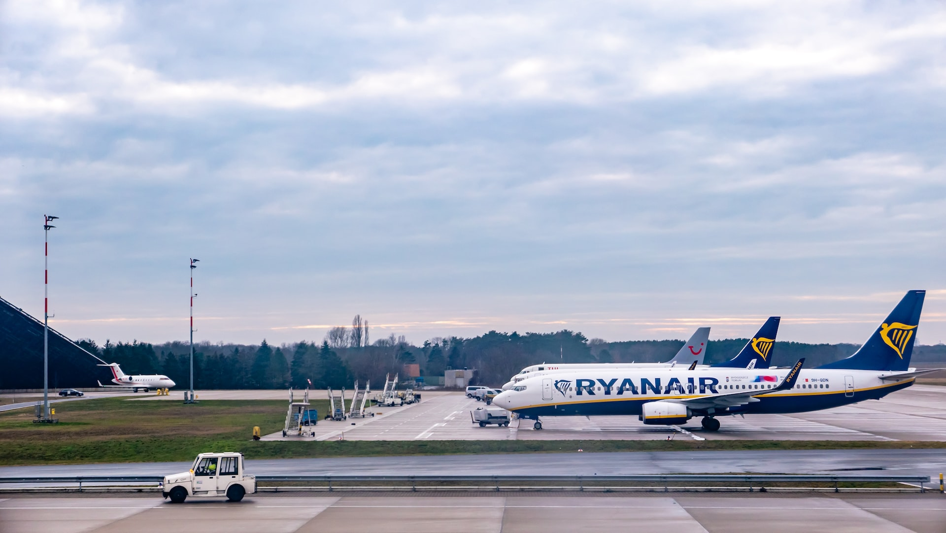 Ryanair aircraft stationed on tarmac at an airport.
