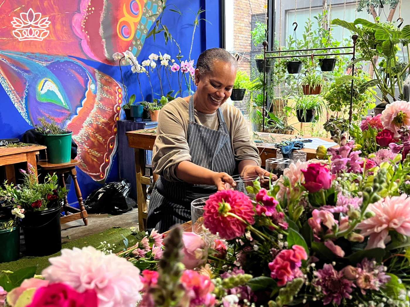 A smiling florist artistically arranging a vibrant selection of pink blooms in a charming flower shop, bringing a touch of nature's beauty to the heart of the city with Fabulous Flowers and Gifts.