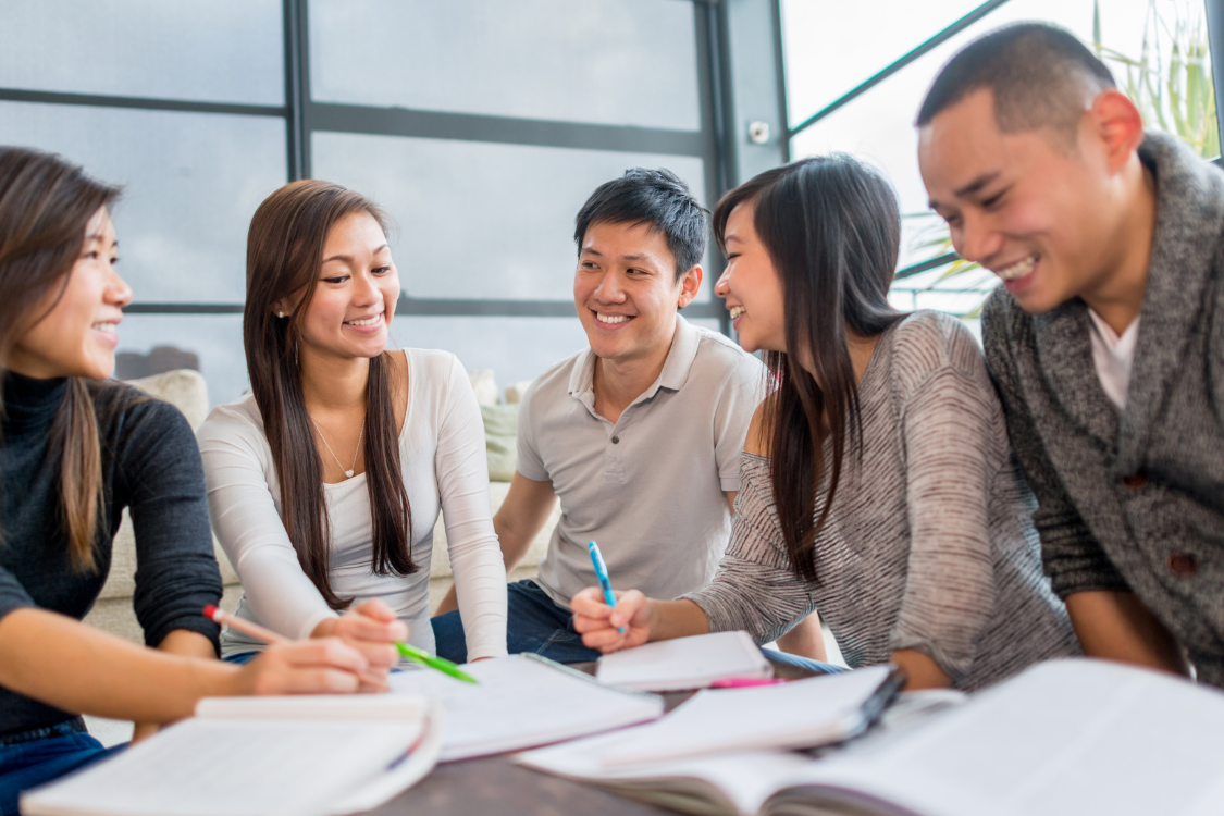 A group of Filipino university students collaborating on schoolwork, symbolizing teamwork and talent sourcing.