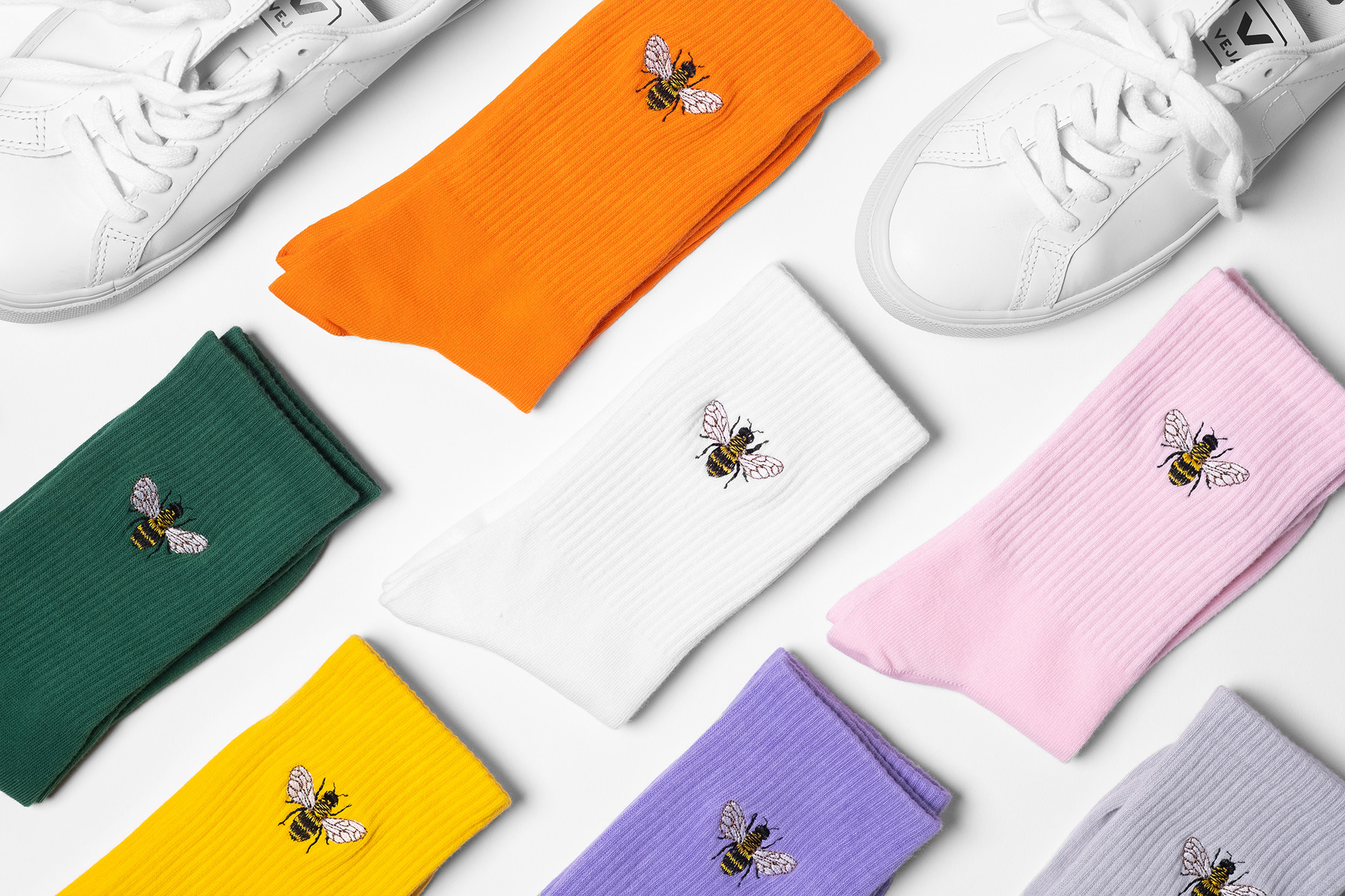 A colourful collection of women crew socks with a bee embroidered on each sock of the pair.