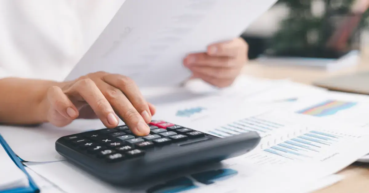 Woman reviewing tax documents and income details to understand the 2026 Social Security tax limit.