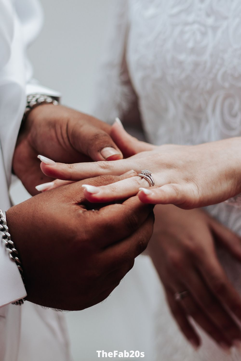 Man putting on a wedding ring on his brides hand - Featured in Signs A Married Man Likes You But Is Hiding It