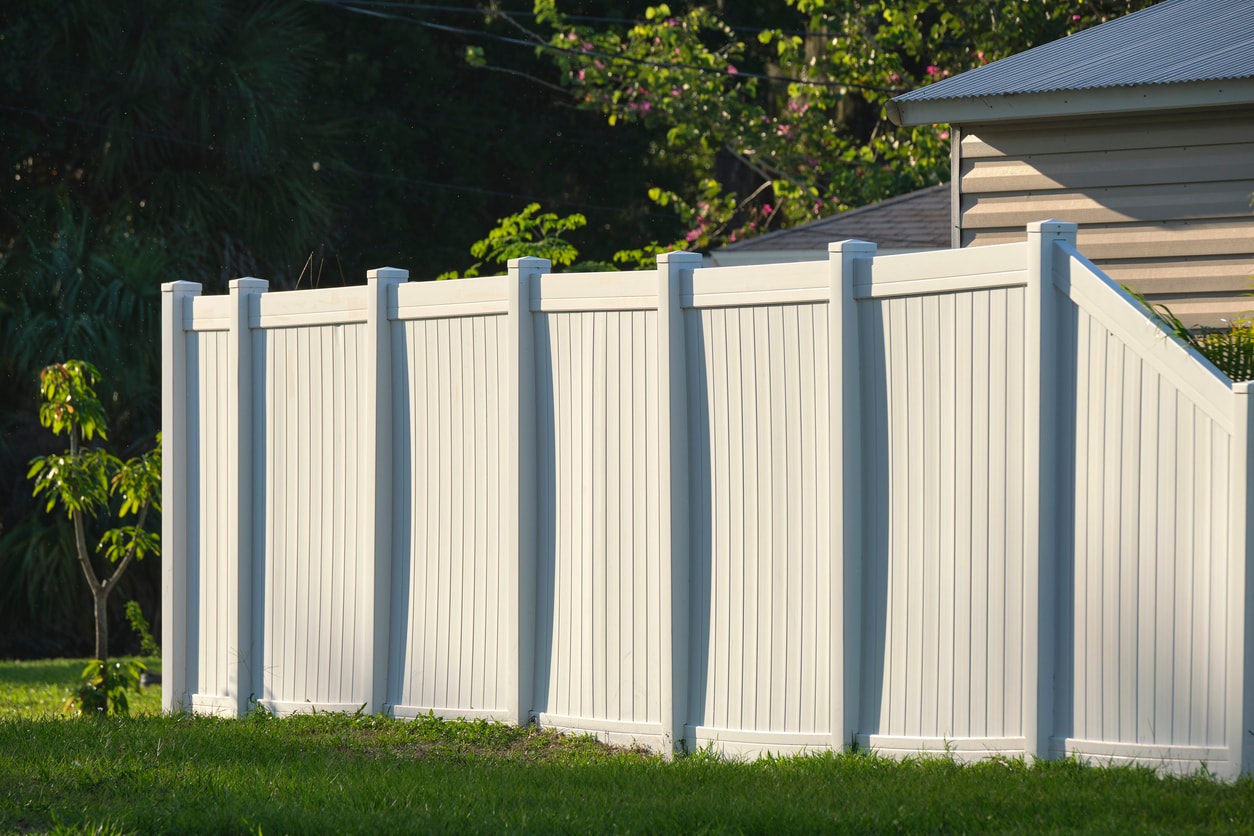 Vinyl PVC house fence installed for privacy.