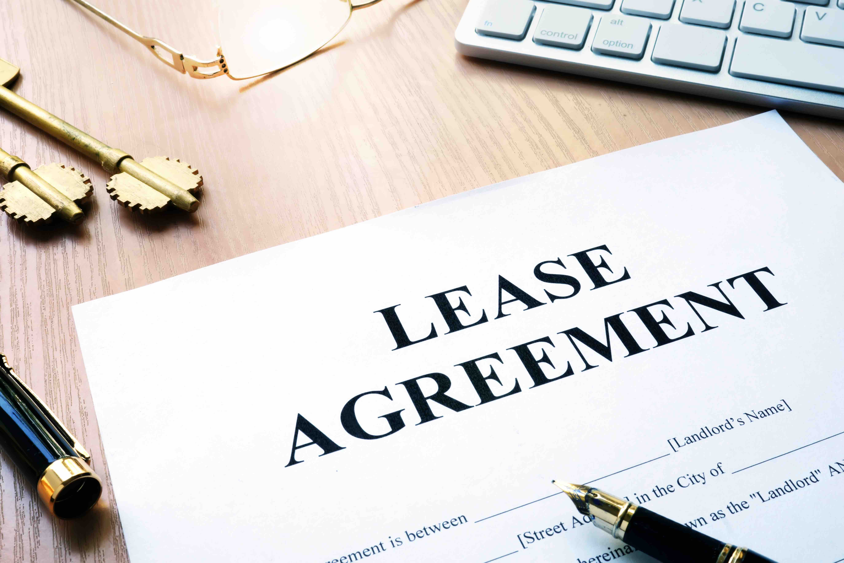 A property manager reviewing a lease agreement with a tenant