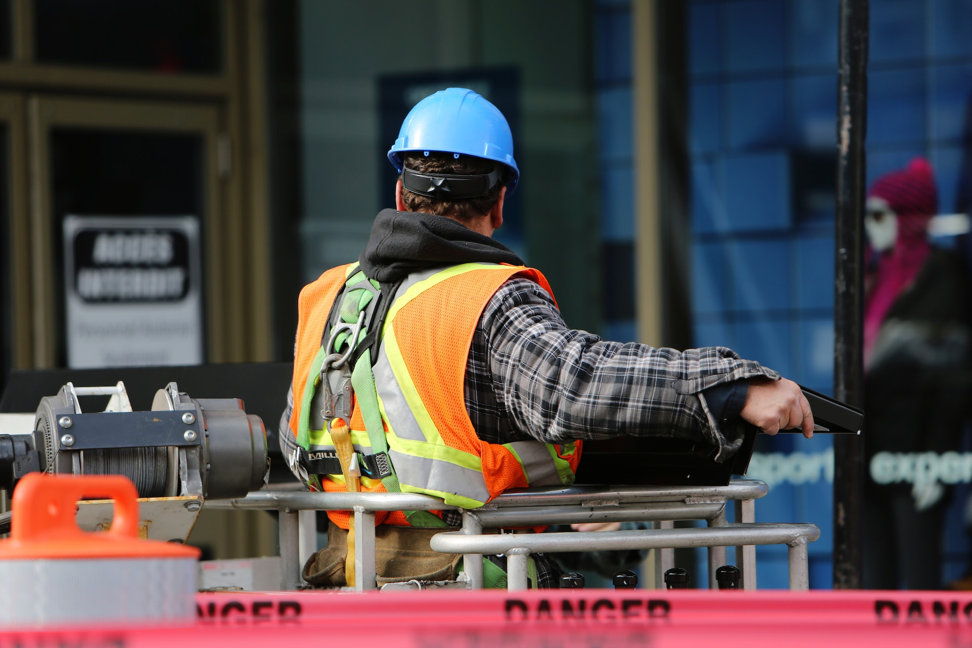 Construction workers in hard hats and safety vests working on a building