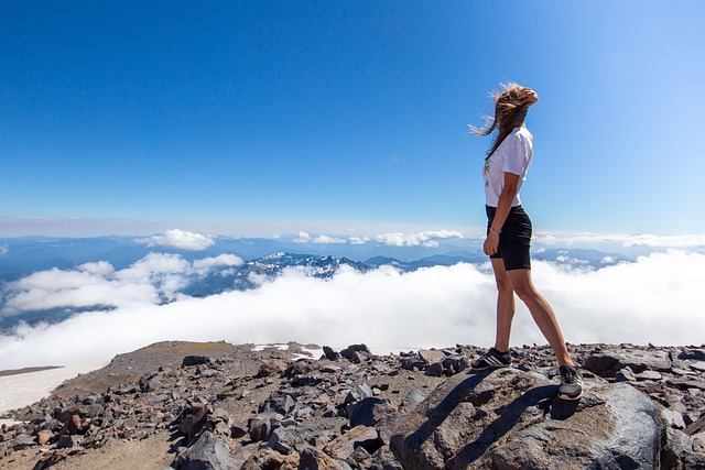 woman on top of mountain symbolizing the successful brand display she's made with her amazon store