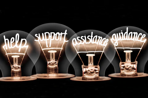 Four lightbulbs with the filaments changed to the following words – help, support assistance and guidance