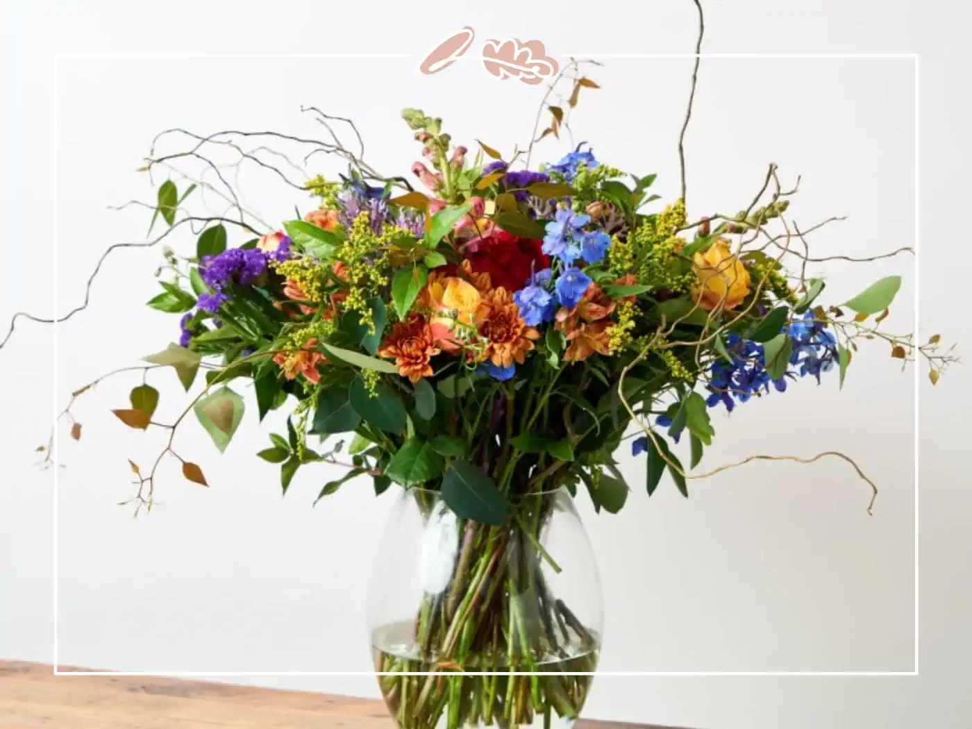 A vibrant bouquet of colorful wildflowers arranged in a clear vase. Fabulous Flowers and Gifts.