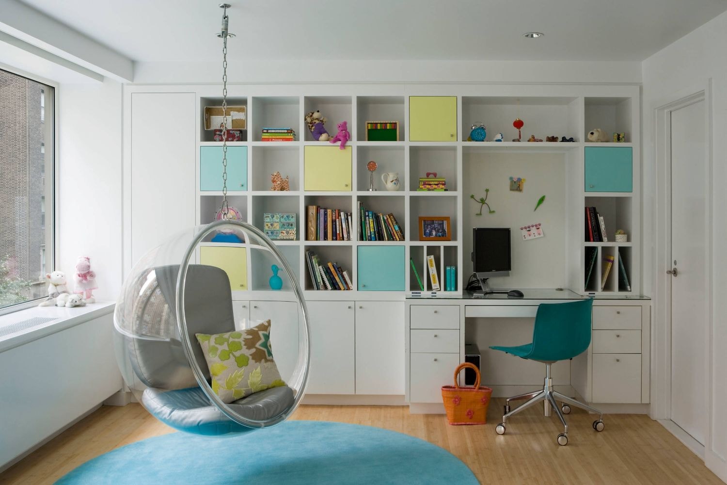 a teen girl bedroom study nook featuring hues of yellow and greens, hanging chair, white cabinets, and smart storages solutions