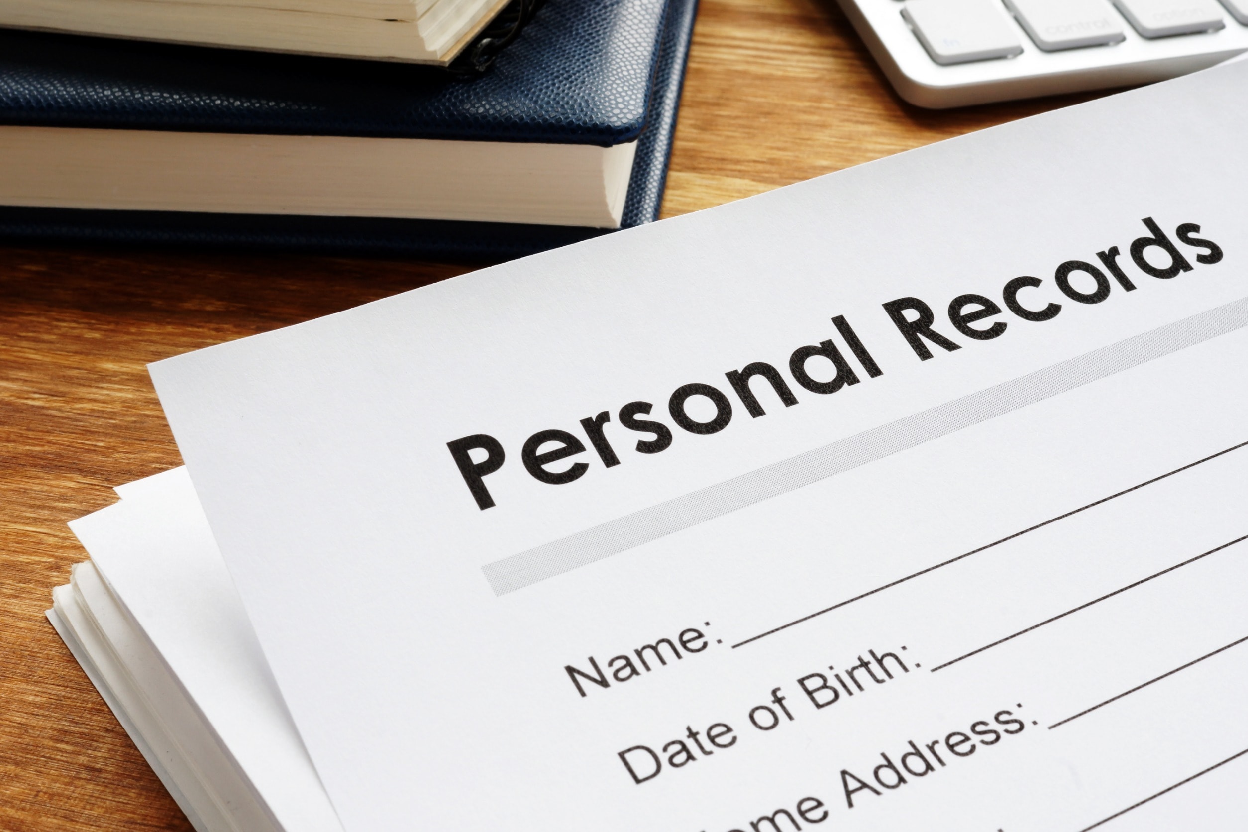 Paper medical records laying on a table after a human error data breach