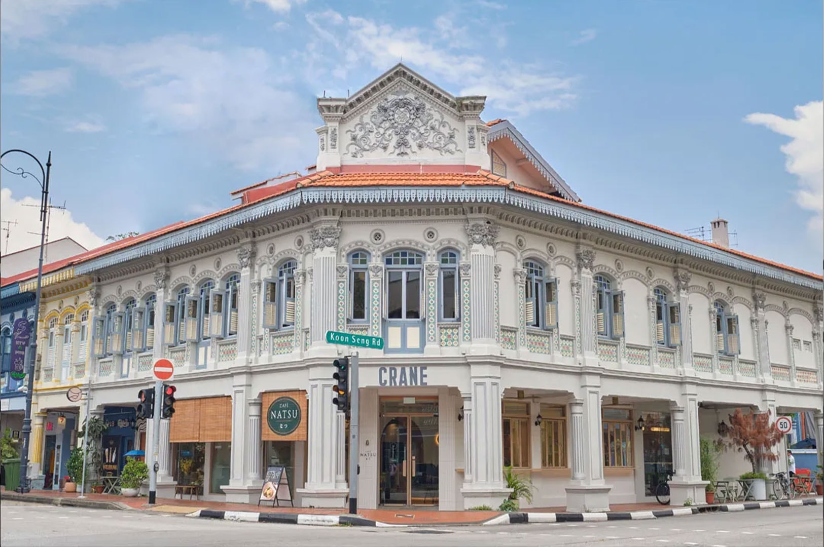 Beautifully preserved, historic corner shophouse with European architectural details in Tiong Bahru, Singapore, housing Cafe Natsu and Crane.