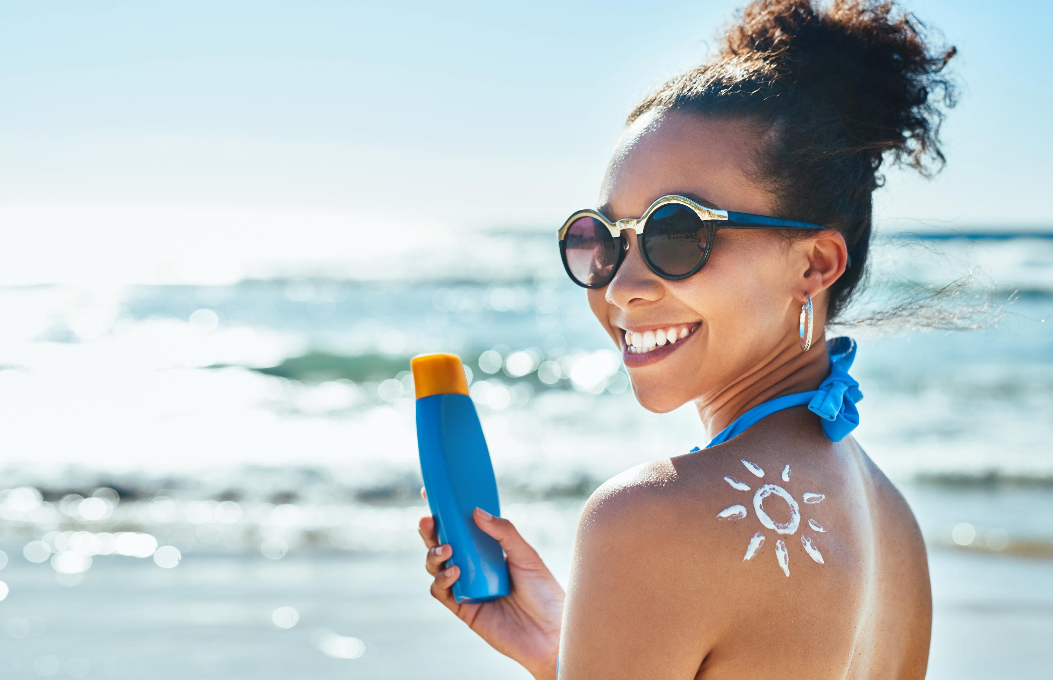 Flat lay of sunscreen products on marble surface UK US