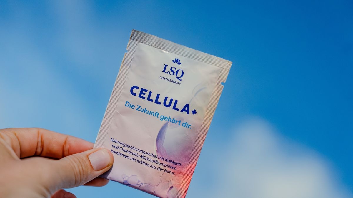 Frau hält ein CELLULA+ Sachet vor strahlend blauem Himmel – Symbol für Reinheit, Energie und natürliche Wirkung