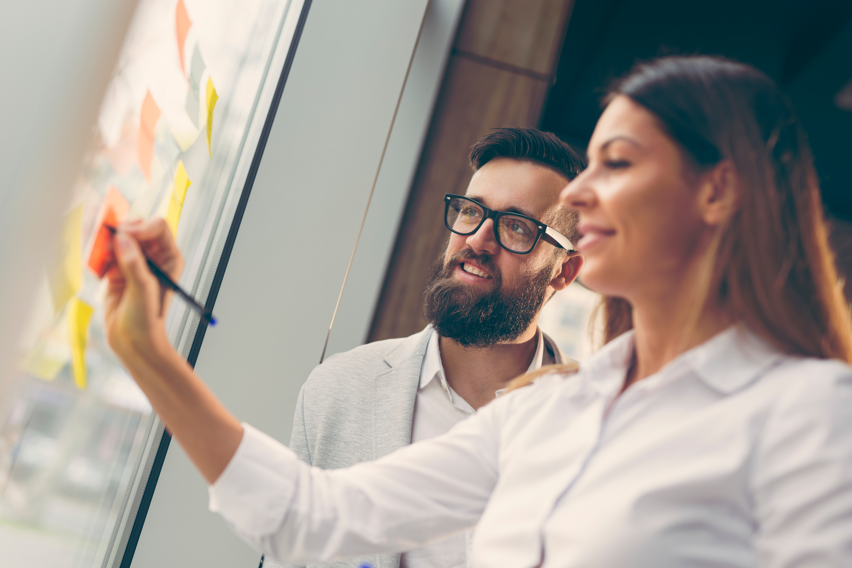  "Asset Protection Strategy: Professionals mapping out safeguards using sticky notes in an office setting."