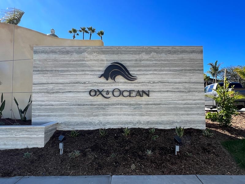 Positioned for visibility, this monument sign highlights OX & Ocean, the hotel’s signature restaurant, with branding that matches the resort’s upscale style.