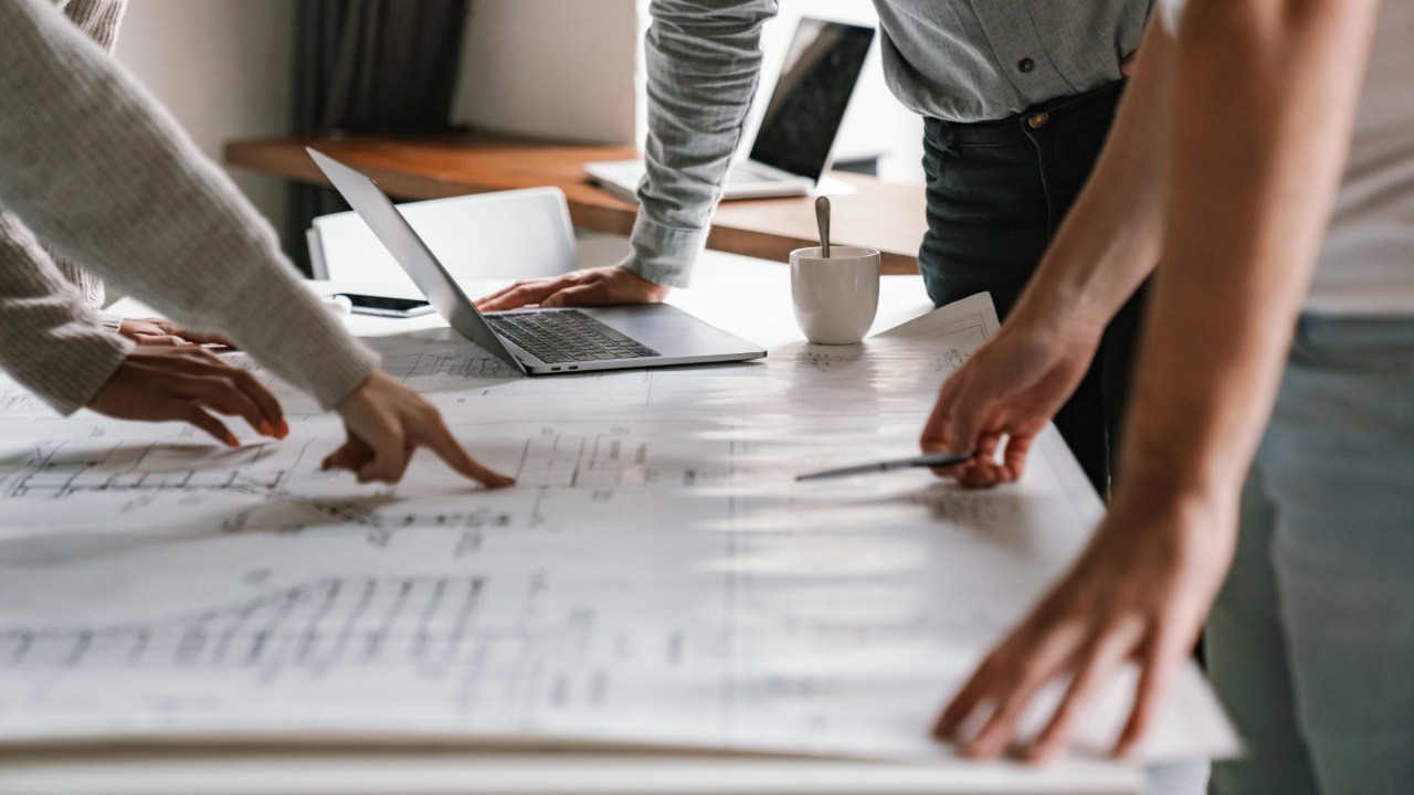 business team reviewing a blueprint