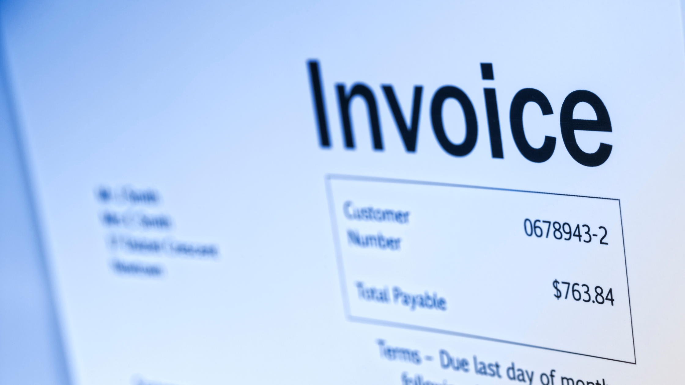 Close-up of an invoice with a due amount, representing the need for telecom billing system automation, timely invoicing, and invoice detail verification.