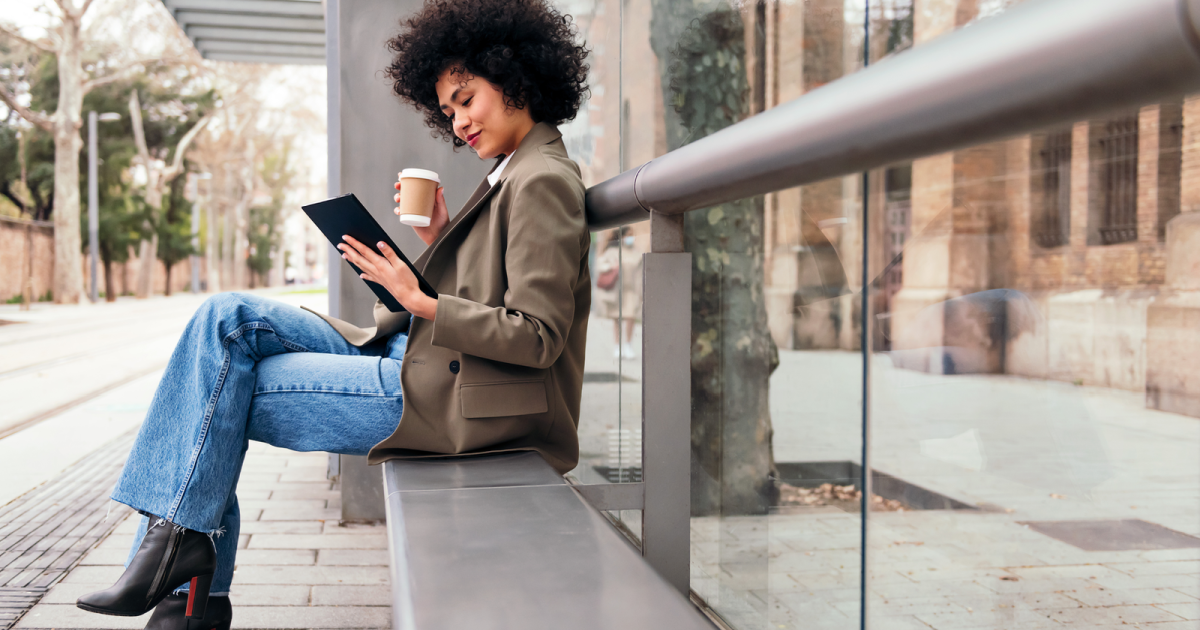 Image of a woman engrossed in reading from a digital device. The screen display is intentionally blurred to represent any online content, but it symbolizes her engagement with GayCouplesTherapy.com. This premier LGBTQ+ couples therapy program provides valuable resources and online counseling for gay and lesbian couples in New York, reflecting a commitment to inclusivity and mental health support in the digital age. She works against dead bedroom syndrome.