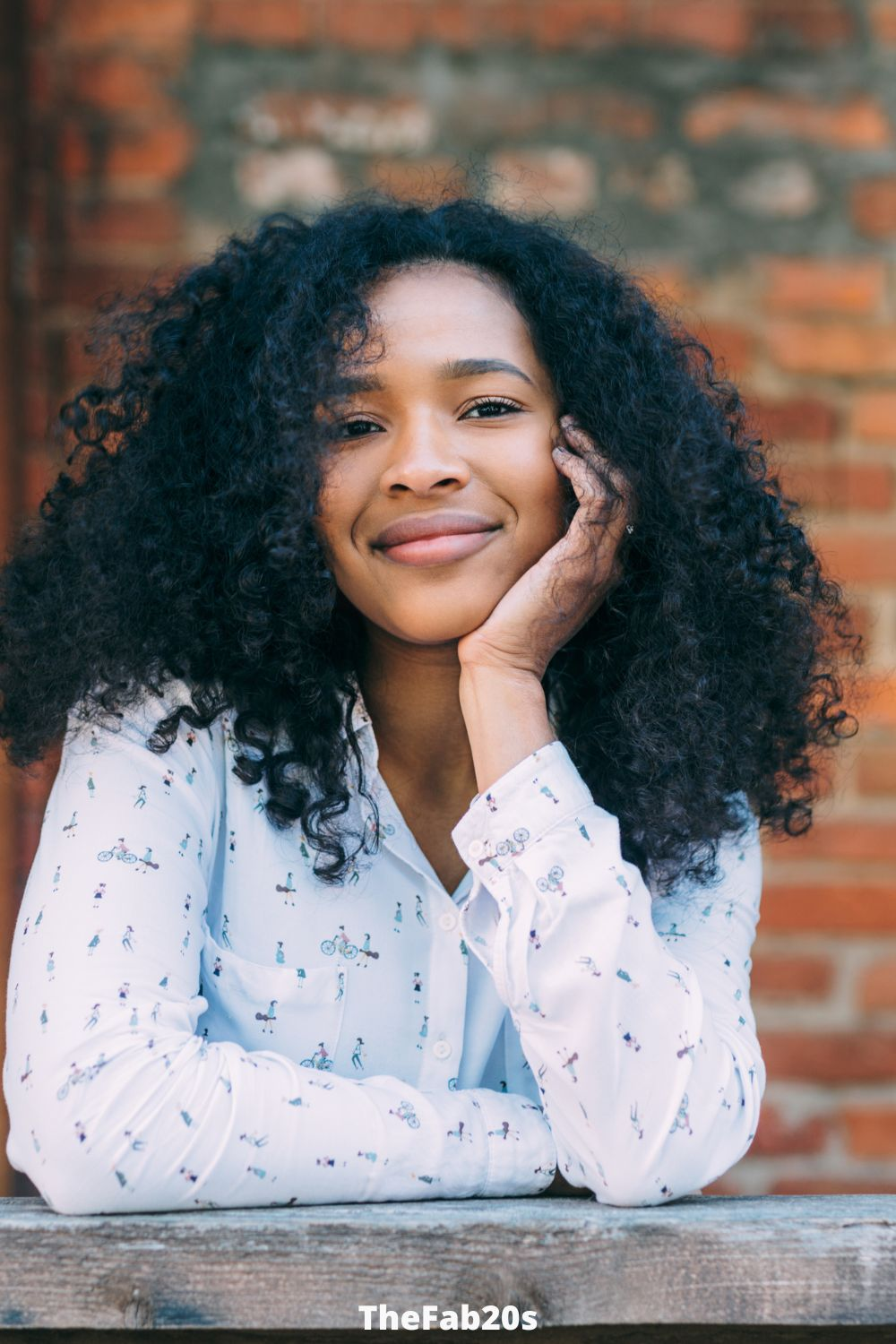 Scorpio women smiling at the camera with hand on cheek - Featured in Why Are Geminis Attracted To Scorpio