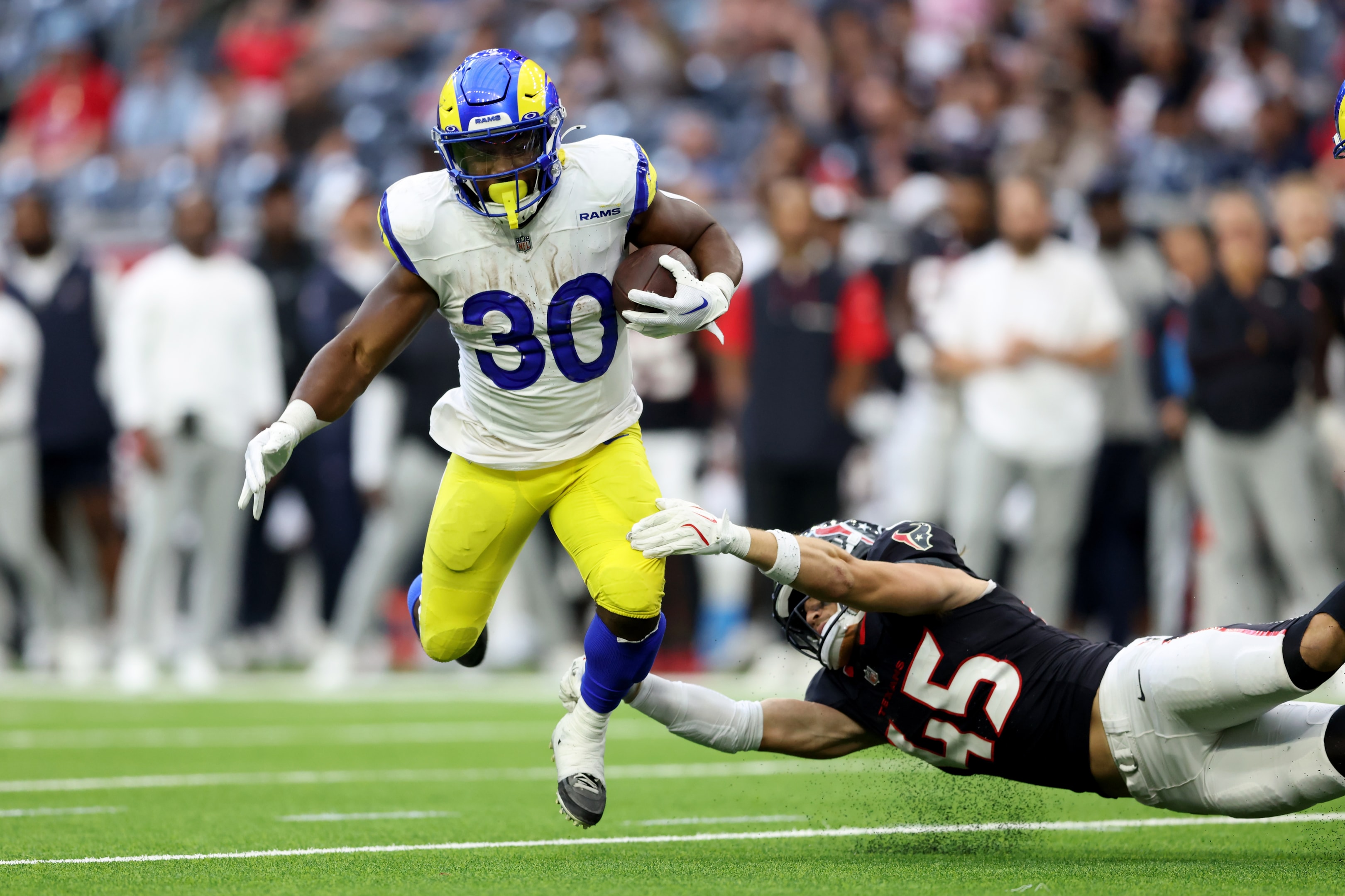 Max Tooley of the Houston Texans tackles Boston Scott of the Los Angeles Rams during a preseason game at NRG Stadium on August 24, 2024 in Houston, Texas.