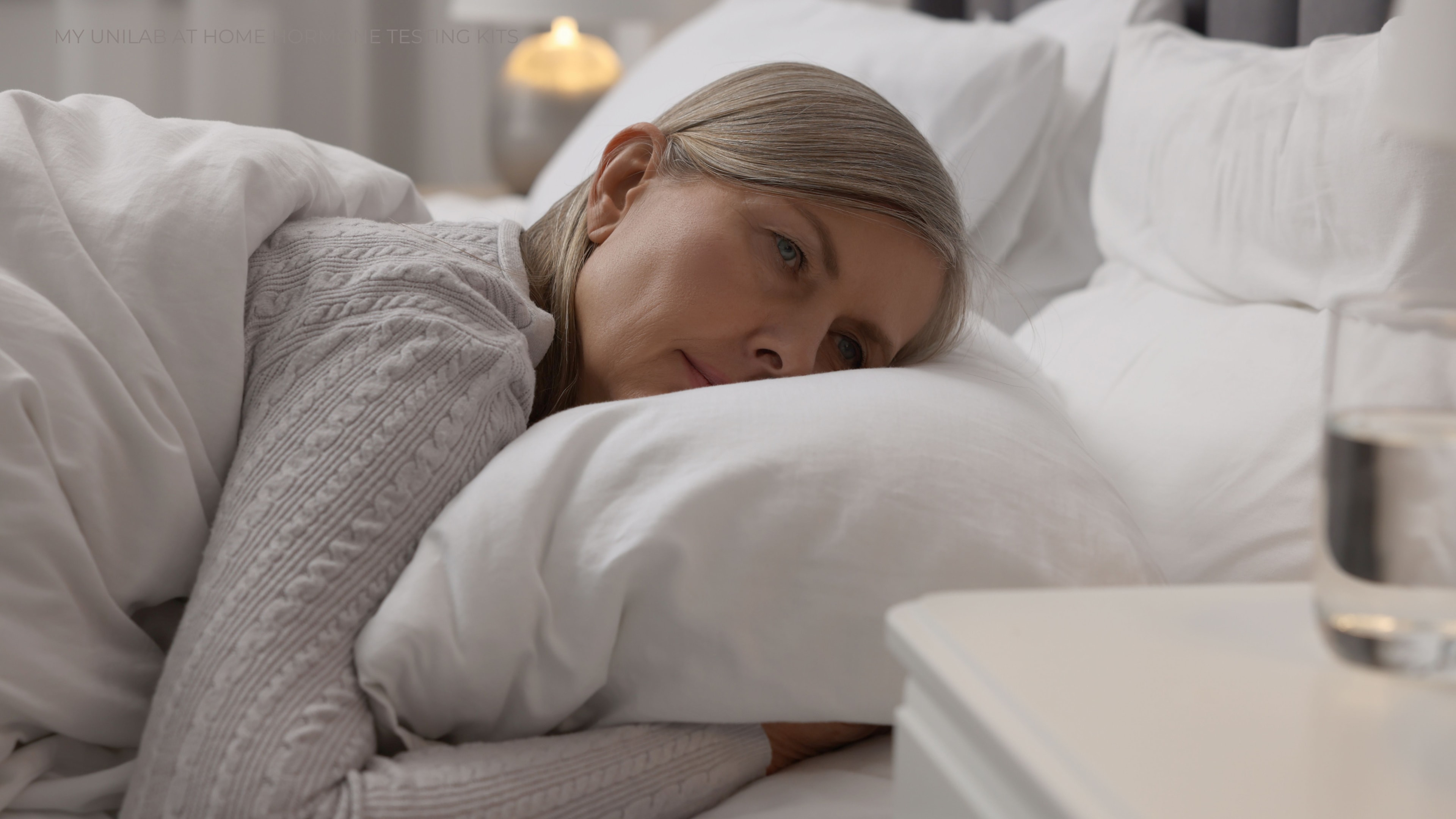 Middle aged women experiencing depression while lying in bed.