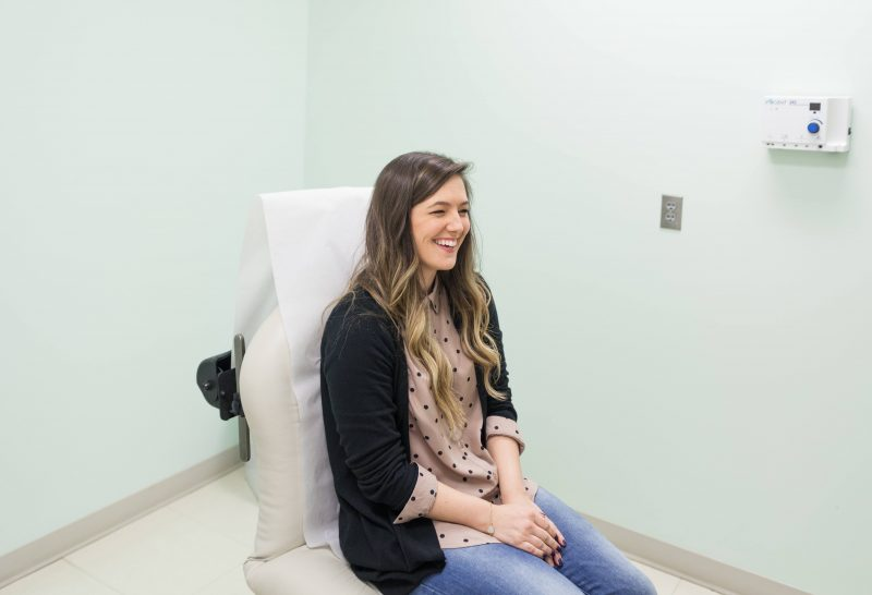 Woman in exam room to discuss polycystic ovary syndrome PCOS