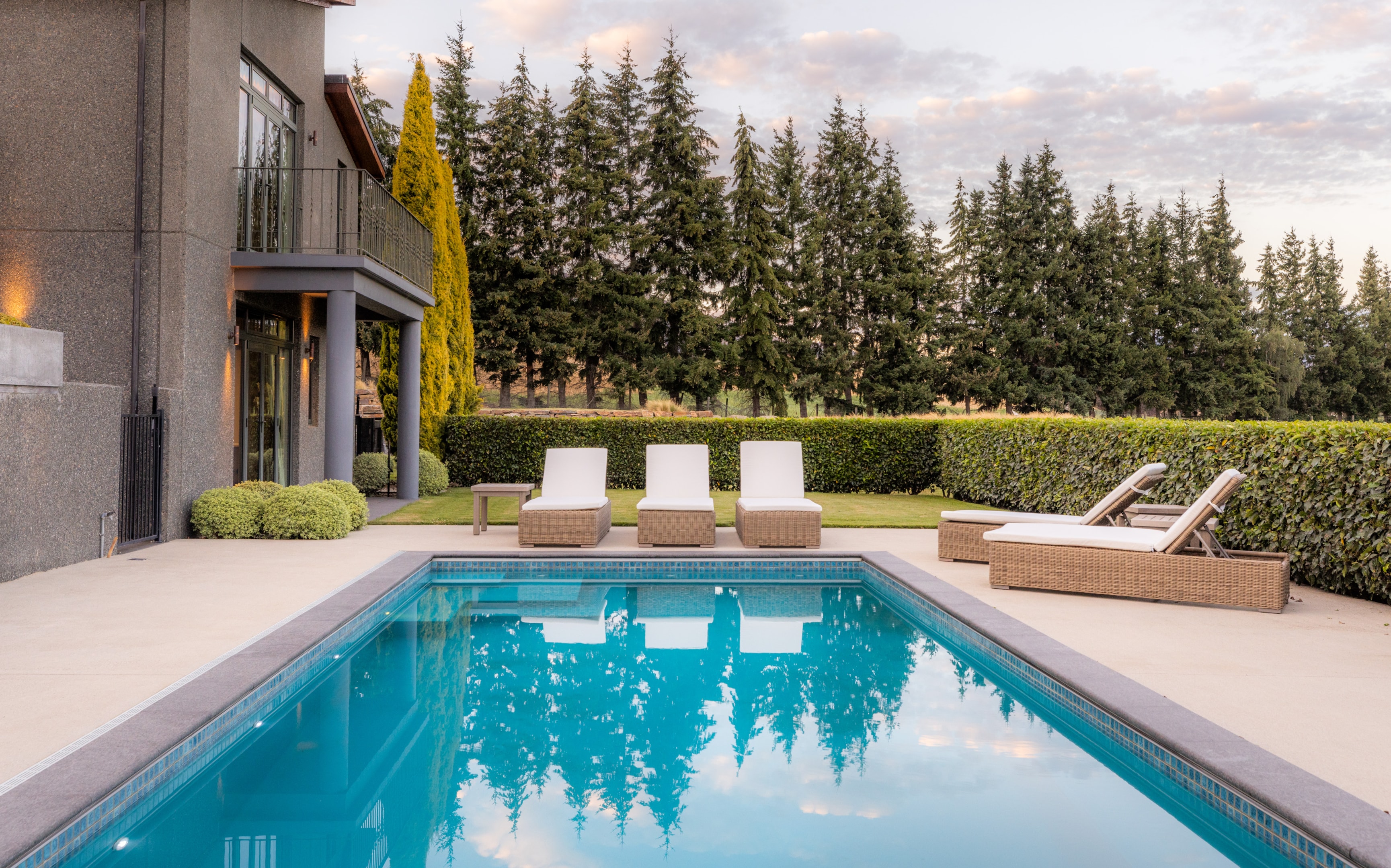 The luxurious pool outside of this lodge with spectacular views of the mountains in the distance. 