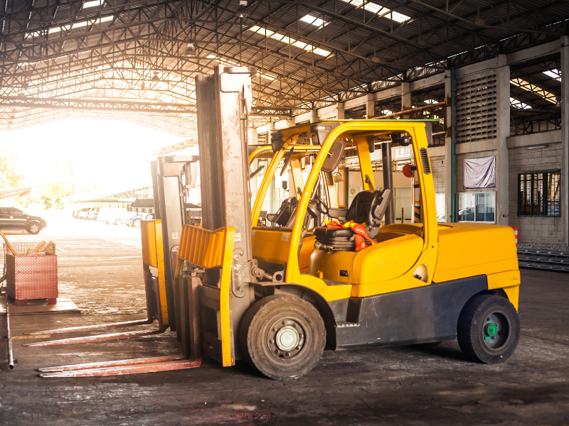 An image showing a forklift parked at a worksite garage.